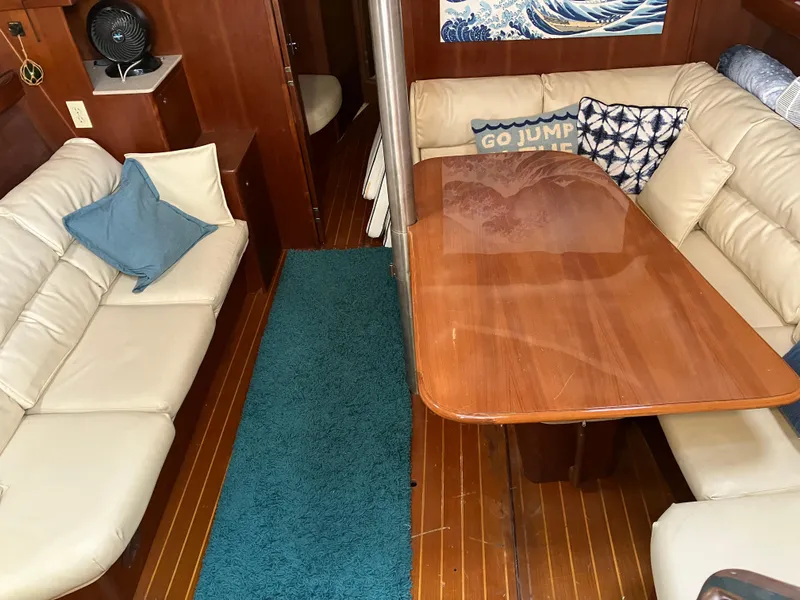 Slide: The Image of Interior of 2001 Hunter Passage 450 yacht with cozy seating and wooden table. - 21