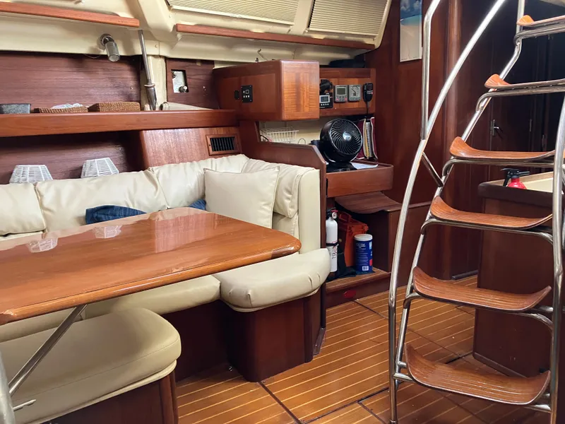 Slide: The Image of Interior of 2001 Hunter Passage 450 sailboat with wooden furnishings and cozy seating area. - 29