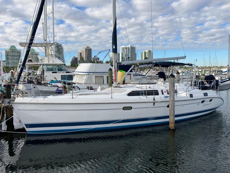 Slide: The Image of 2001 Hunter Passage 450 sailboat docked in marina with city skyline background. - 3