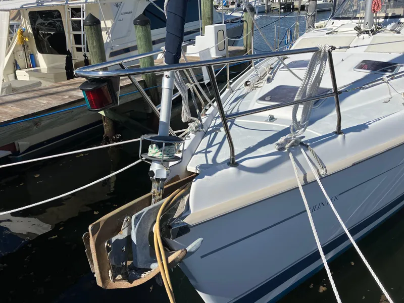 Slide: The Image of Sailboat Hunter Passage 450, 2001 model, docked at marina with anchor and ropes visible. - 32