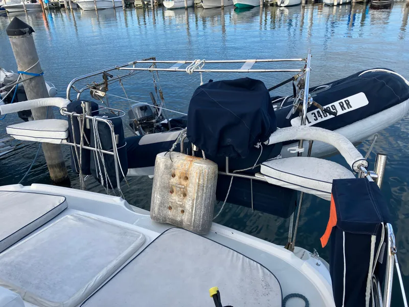 Slide: The Image of Hunter Passage 450 sailboat stern with dinghy, docked in a marina, 2001 model. - 4