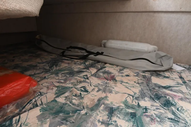 Slide: The Image of Interior cabin of 1998 Sea Ray 240 Sundancer with abstract-patterned bedding. - 16