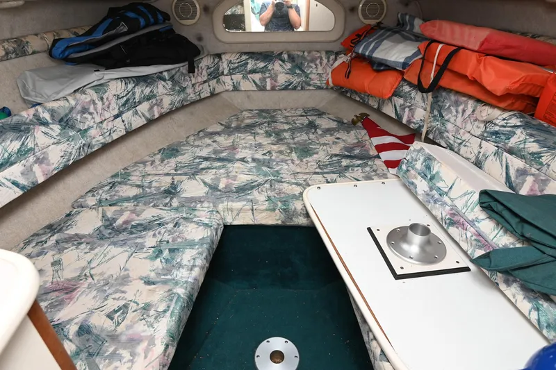 Slide: The Image of Interior of 1998 Sea Ray 240 Sundancer boat with patterned seating and storage. - 21