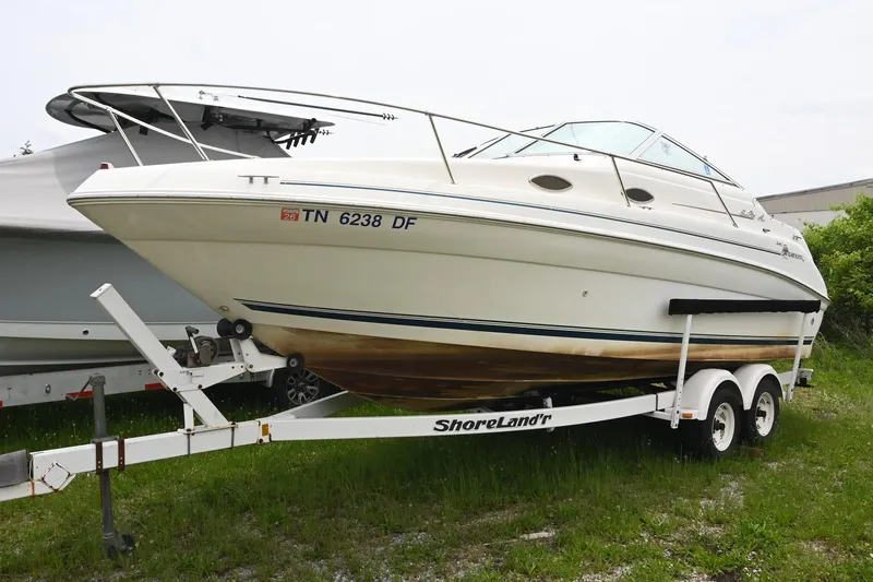 Slide: The Image of 1998 Sea Ray 240 Sundancer boat on ShoreLand'r trailer, parked on grass. - 4