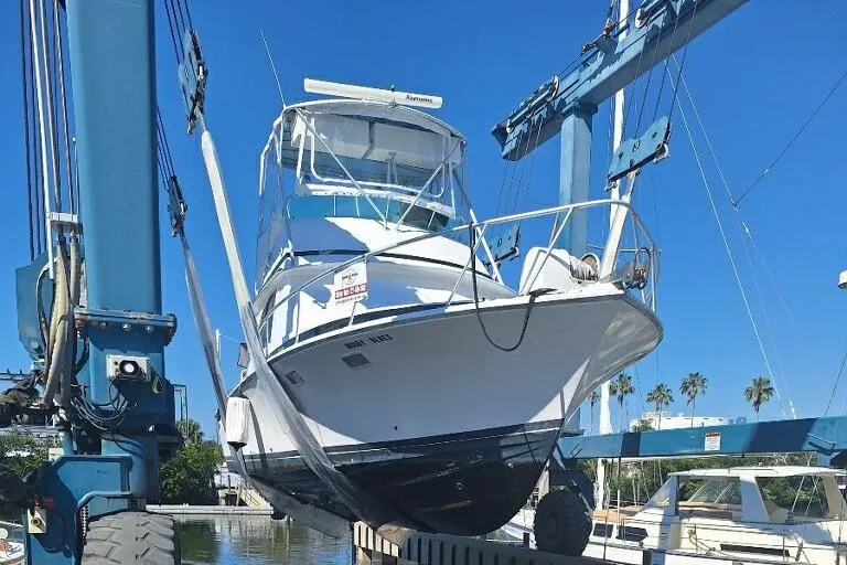Slide: The Image of 1979 Bertram 35 Sport Fisherman boat on lift at marina. - 1