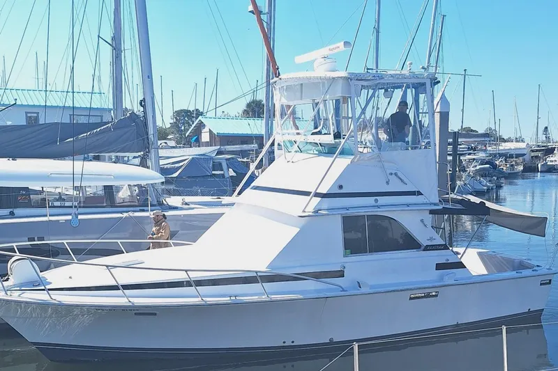 Slide: The Image of 1979 Bertram 35 Sport Fisherman boat docked in a marina. - 2