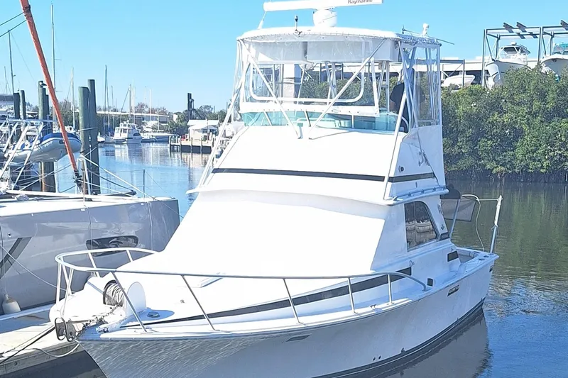 Slide: The Image of 1979 Bertram 35 Sport Fisherman boat docked in a marina. - 3
