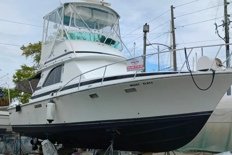 Slide: The Image of 1979 Bertram 35 Sport Fisherman boat on dry dock, white hull, marina background. - 8