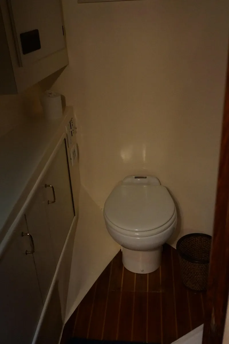 Slide: The Image of 1988 Ocean Yachts Super Sport bathroom with toilet and cabinetry. - 12