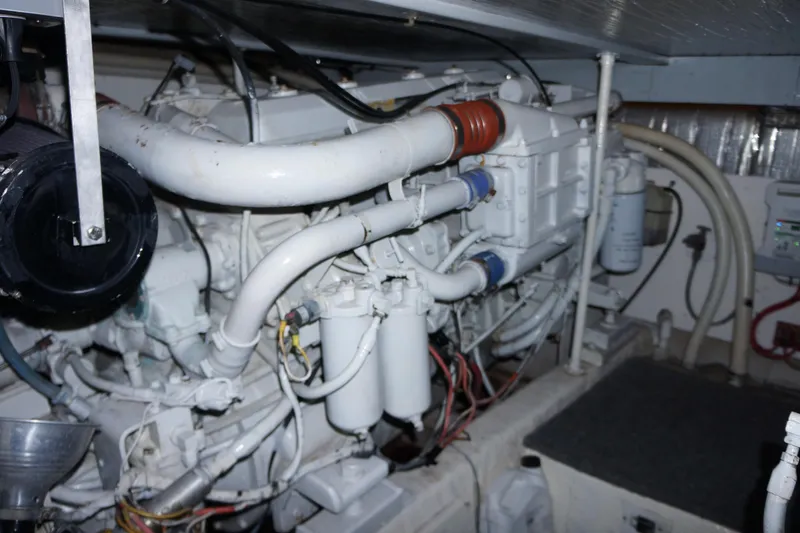 Slide: The Image of Engine room of 1988 Ocean Yachts Super Sport, showcasing complex machinery and components. - 15