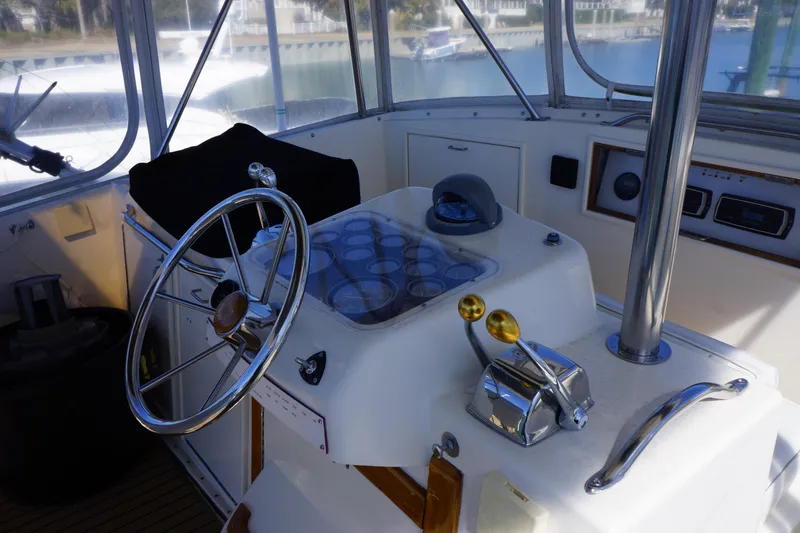 Slide: The Image of 1988 Ocean Yachts Super Sport helm with steering wheel and controls. - 24