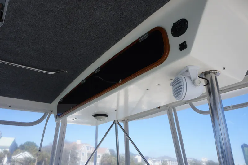Slide: The Image of 1988 Ocean Yachts Super Sport interior ceiling with speaker and storage compartment. - 25