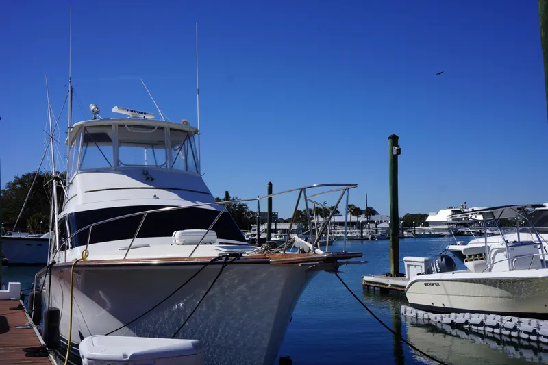 Slide: The Image of 1988 Ocean Yachts Super Sport docked at a marina under clear blue skies. - 33