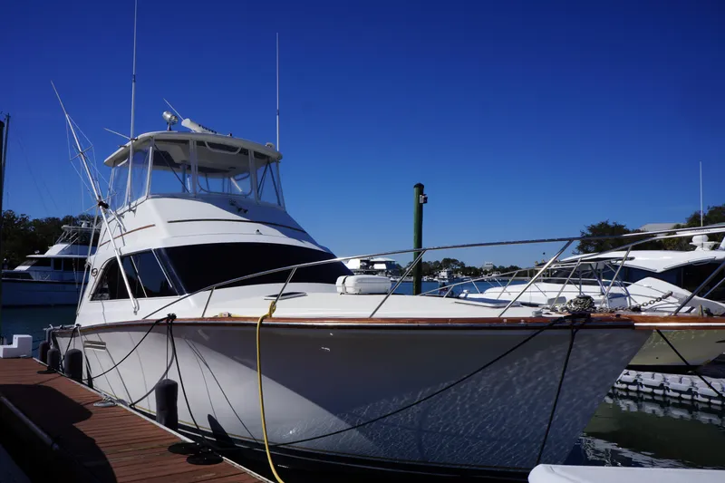 Slide: The Image of 1988 Ocean Yachts Super Sport docked at marina under clear blue sky. - 34