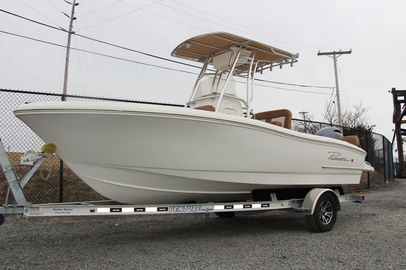 The Image of 2025 Pioneer 202 Sportfish boat on trailer, parked outdoors. - 0