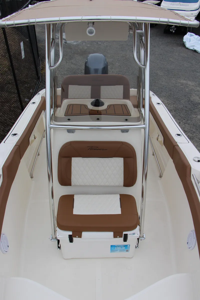 Slide: The Image of 2025 Pioneer 202 Sportfish boat interior with tan and white seating. - 11