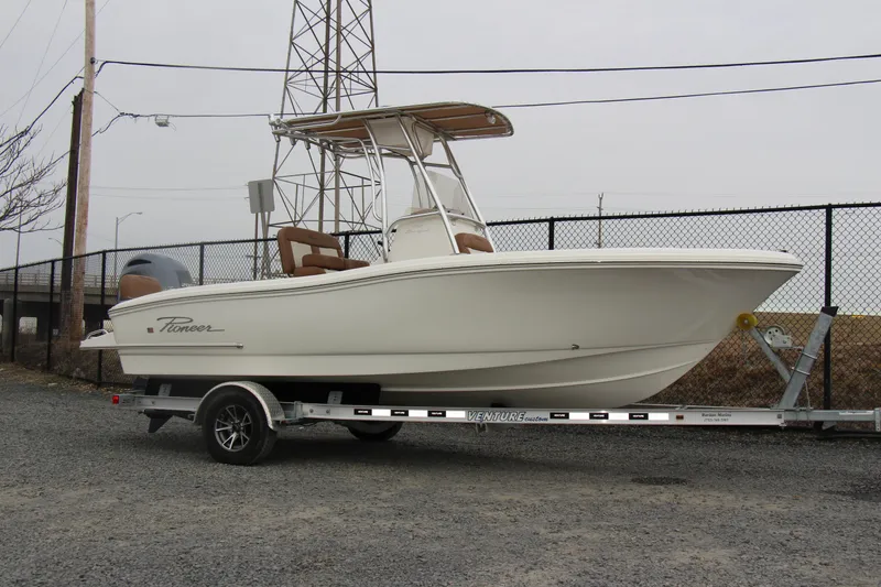 Slide: The Image of 2025 Pioneer 202 Sportfish boat on trailer, parked outdoors. - 13