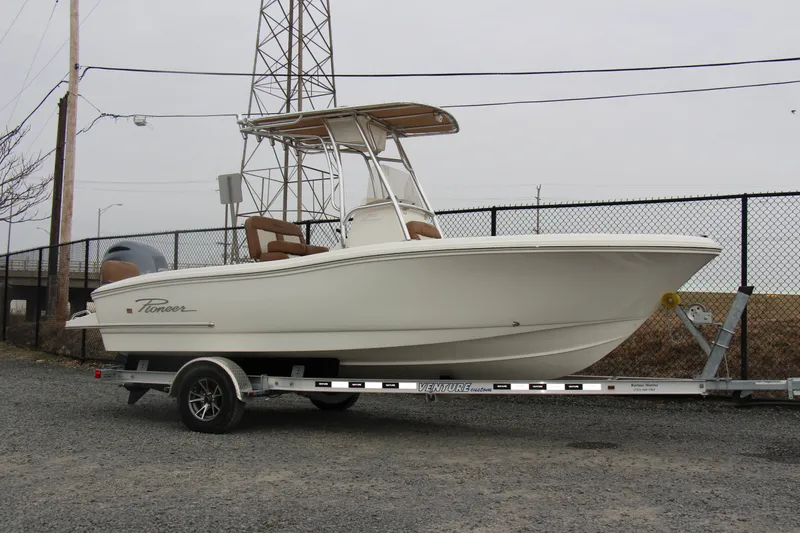 Slide: The Image of 2025 Pioneer 202 Sportfish boat on trailer, parked outdoors. - 14