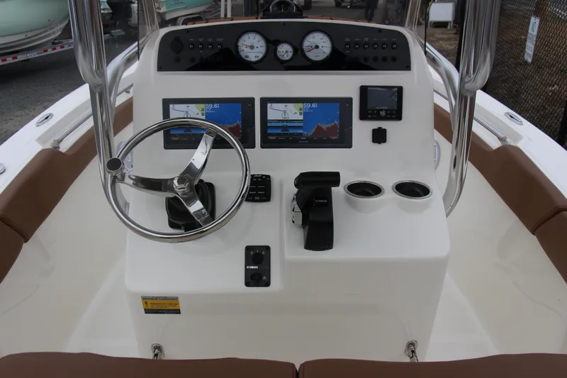 Slide: The Image of 2025 Pioneer 202 Sportfish boat dashboard with steering wheel and navigation screens. - 3