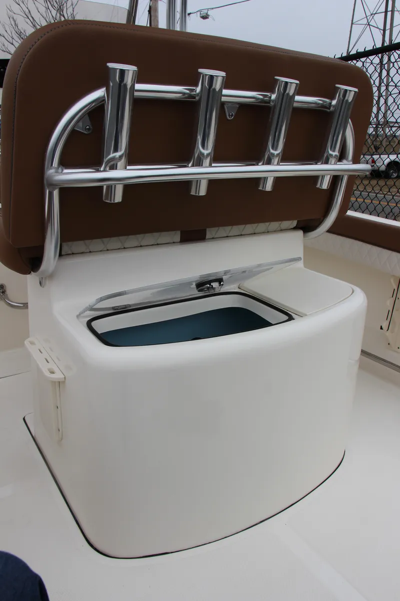 Slide: The Image of 2025 Pioneer 202 Sportfish boat with rod holders and storage compartment. - 5