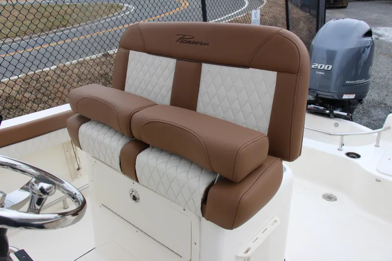Slide: The Image of 2025 Pioneer 202 Sportfish boat seat with brown and white upholstery. - 7
