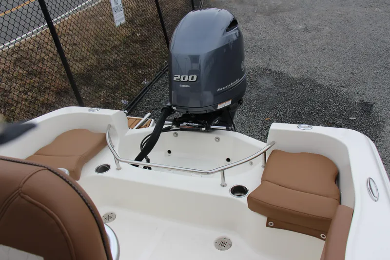 Slide: The Image of 2025 Pioneer 202 Sportfish boat with Yamaha 200 engine, featuring cushioned seating. - 9