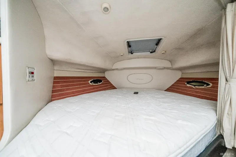 Slide: The Image of 2001 Bayliner 3055 Ciera cabin interior with bed and portholes. - 10