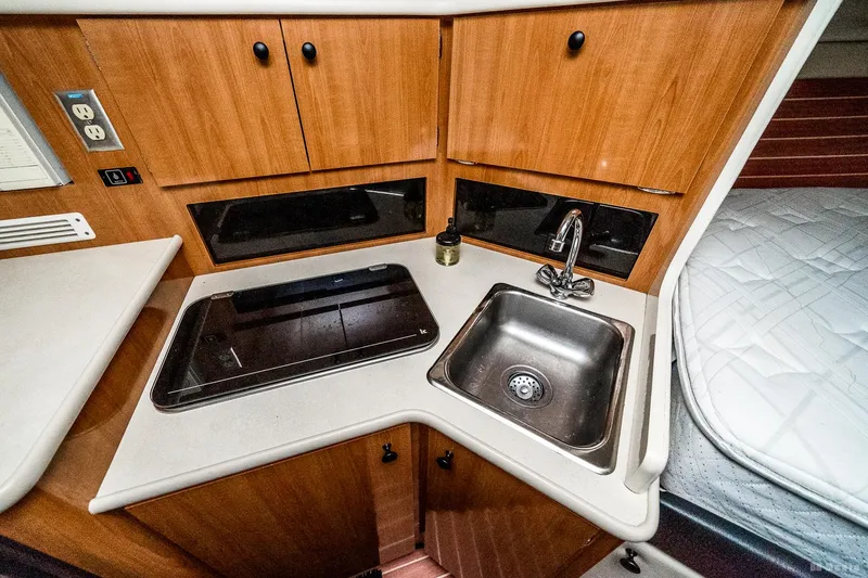 Slide: The Image of 2001 Bayliner 3055 Ciera interior kitchen with sink and stove. - 11