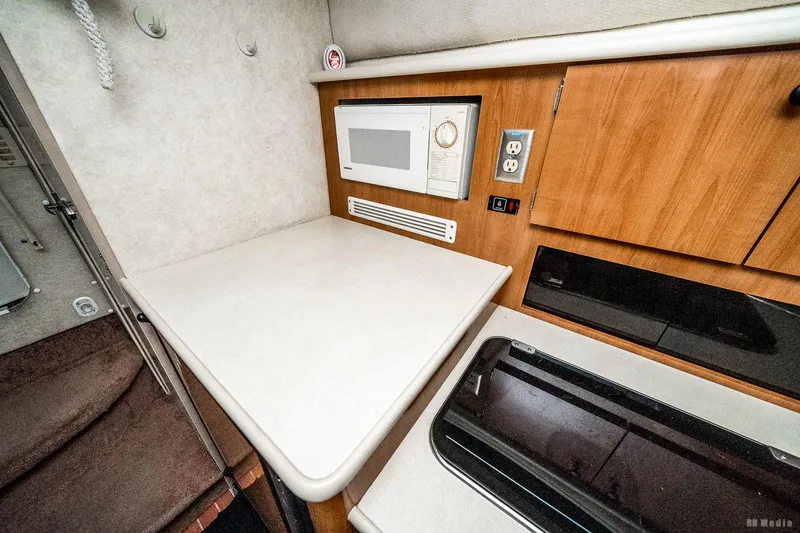 Slide: The Image of 2001 Bayliner 3055 Ciera cabin kitchen with microwave and countertop. - 12