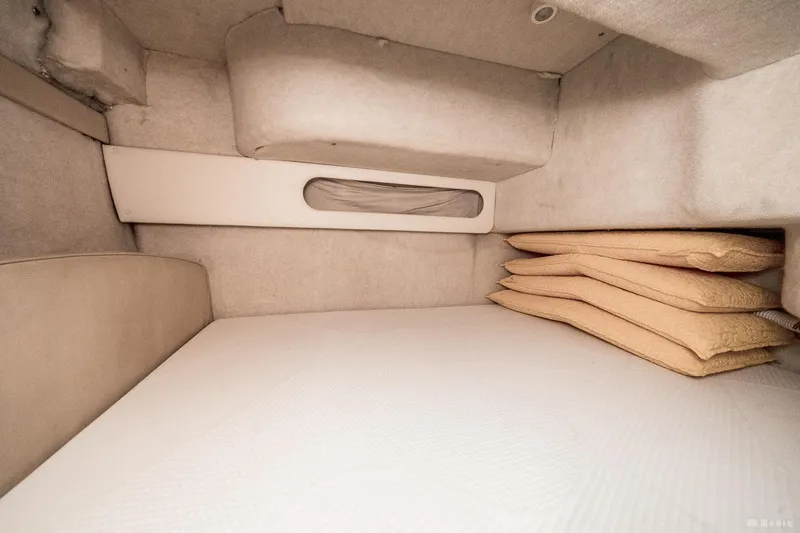 Slide: The Image of Interior cabin of 2001 Bayliner 3055 Ciera with beige cushions and compact design. - 14