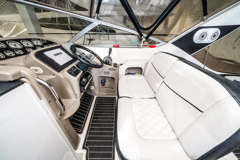 Slide: The Image of 2001 Bayliner 3055 Ciera boat interior with white seating and modern dashboard. - 17