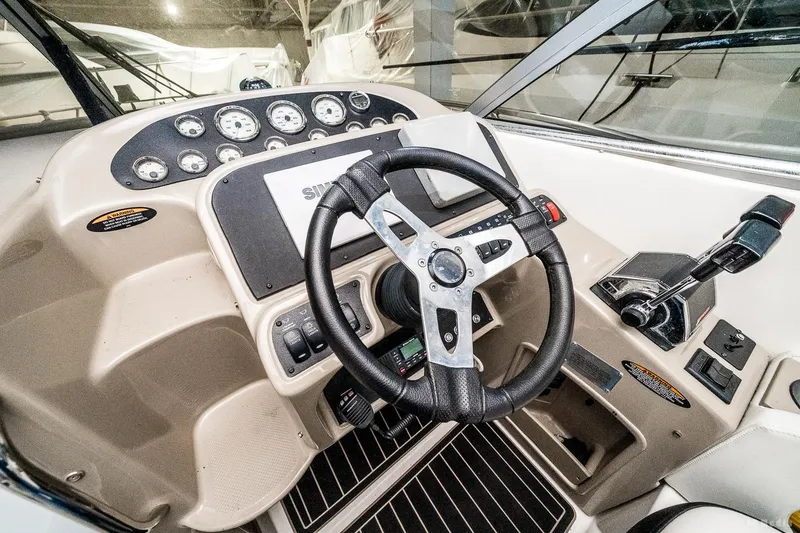 Slide: The Image of 2001 Bayliner 3055 Ciera helm with steering wheel and control panel. - 19