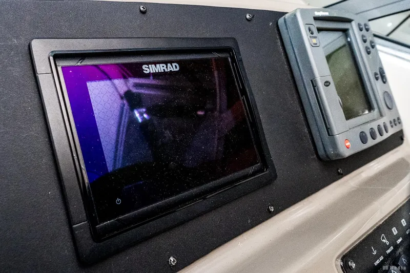 Slide: The Image of Dashboard of a 2001 Bayliner 3055 Ciera with Simrad navigation equipment. - 24