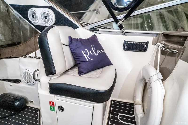 Slide: The Image of 2001 Bayliner 3055 Ciera interior with cushioned seating and "Relax" pillow. - 26