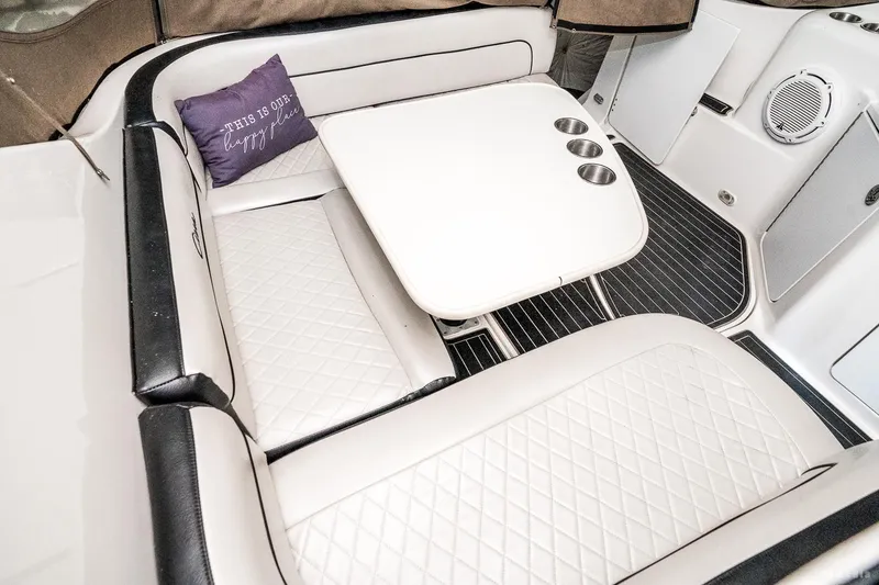 Slide: The Image of 2001 Bayliner 3055 Ciera interior with white seating and table, featuring cup holders. - 28