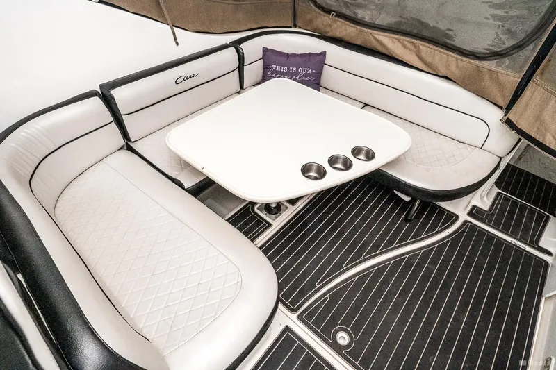 Slide: The Image of 2001 Bayliner 3055 Ciera interior with cushioned seating and table. - 29