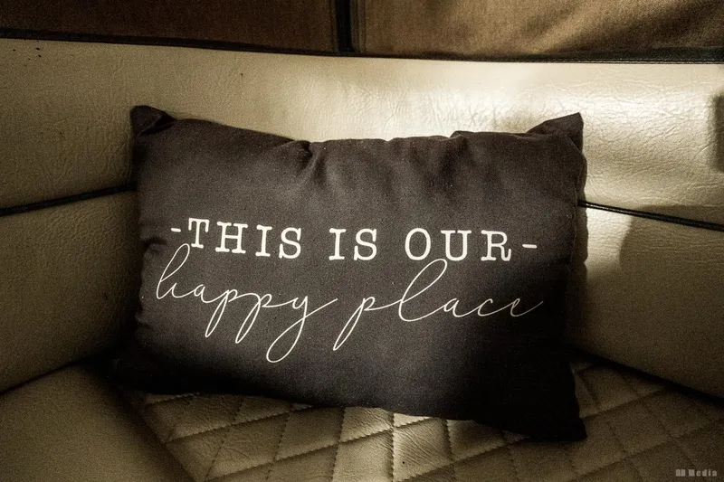 Slide: The Image of Cushion with "This is our happy place" text on Bayliner 3055 Ciera boat seat. - 30