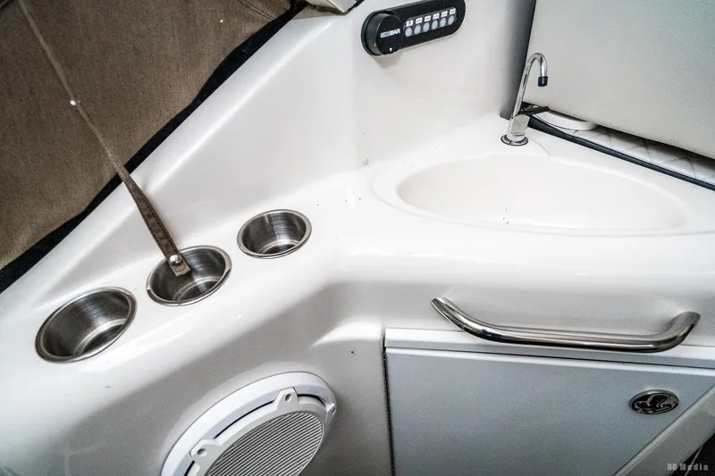 Slide: The Image of Interior of 2001 Bayliner 3055 Ciera boat, featuring sink and cup holders. - 32