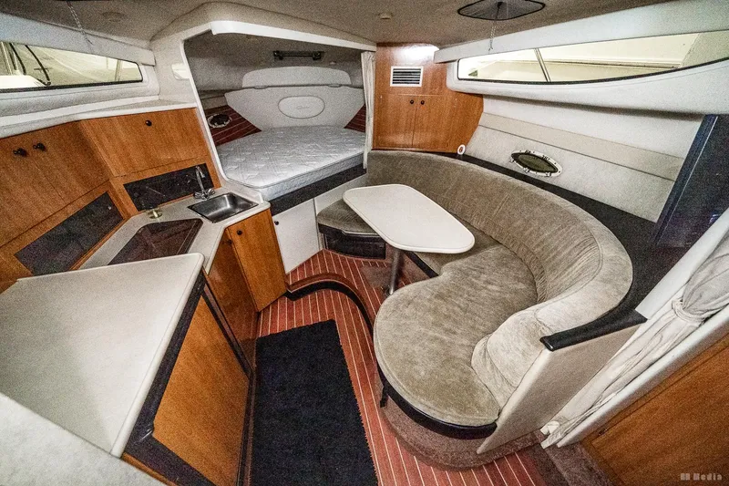 Slide: The Image of Interior of 2001 Bayliner 3055 Ciera boat with cozy seating and compact kitchen area. - 5