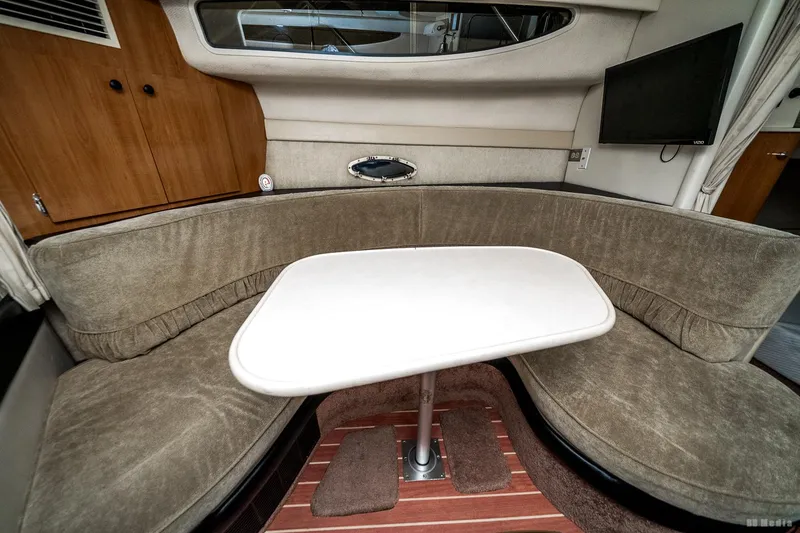 Slide: The Image of Interior of 2001 Bayliner 3055 Ciera with cozy seating and table. - 7