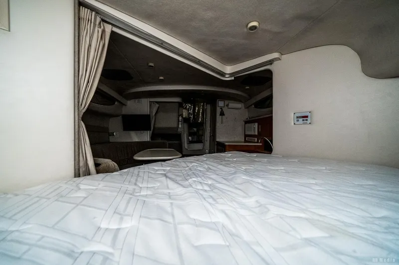 Slide: The Image of Interior cabin of a 2001 Bayliner 3055 Ciera boat, featuring a bed and seating area. - 8