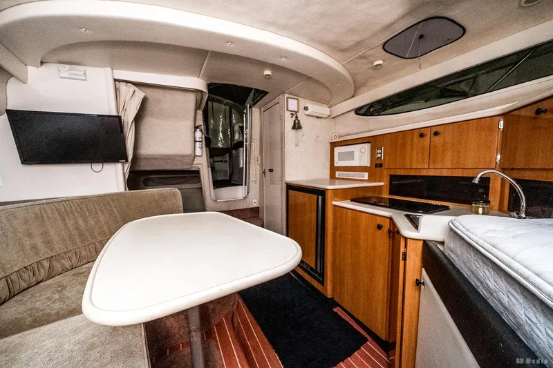 Slide: The Image of Interior of 2001 Bayliner 3055 Ciera boat with kitchen and seating area. - 9