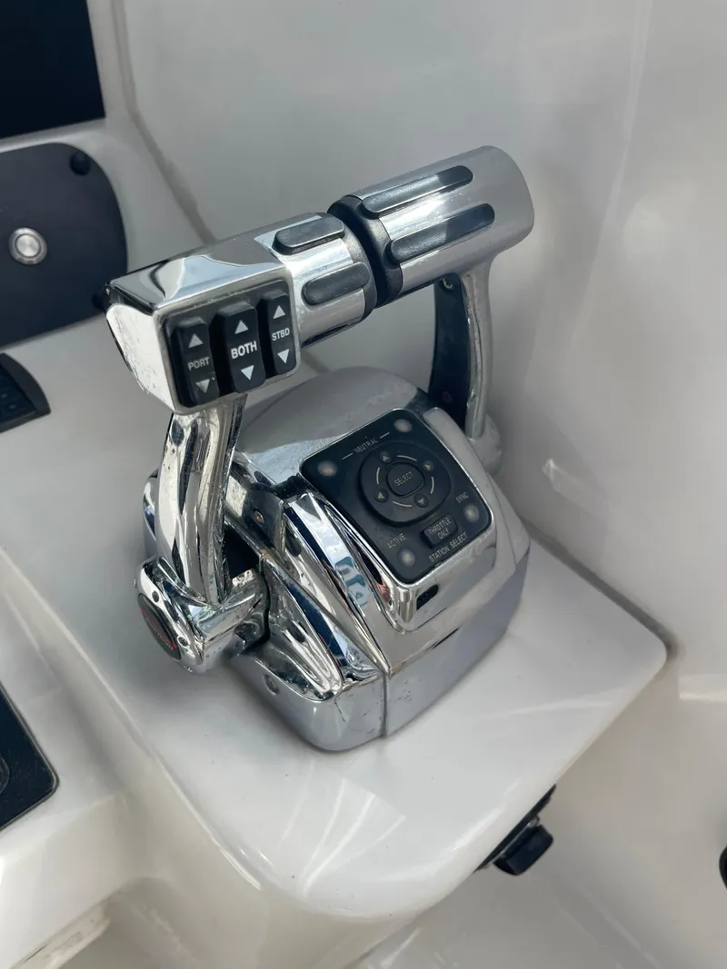 Slide: The Image of Throttle controls on a 2004 Boston Whaler 305 Conquest boat, featuring dual levers. - 14
