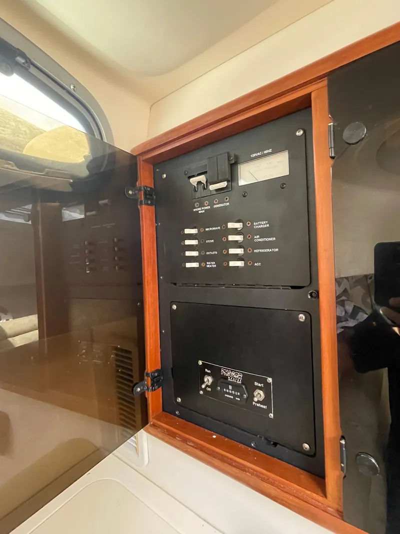 Slide: The Image of Electrical panel inside a 2004 Boston Whaler 305 Conquest boat cabin. - 39