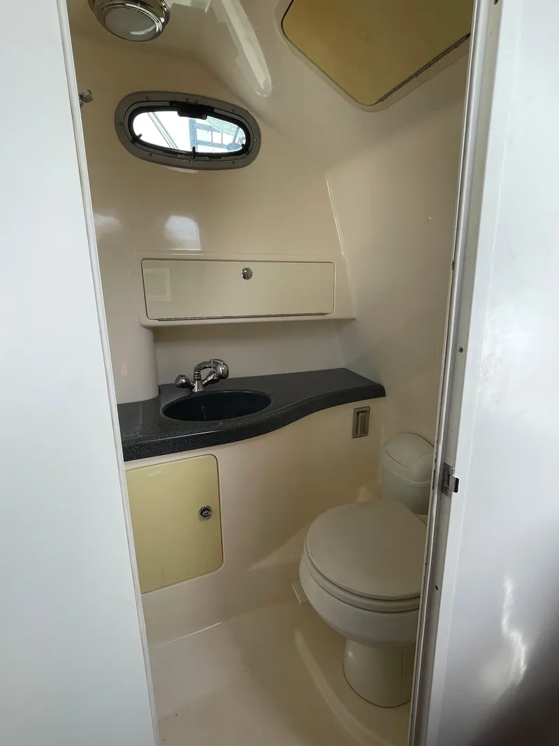 Slide: The Image of 2004 Boston Whaler 305 Conquest boat bathroom with sink and toilet. - 52