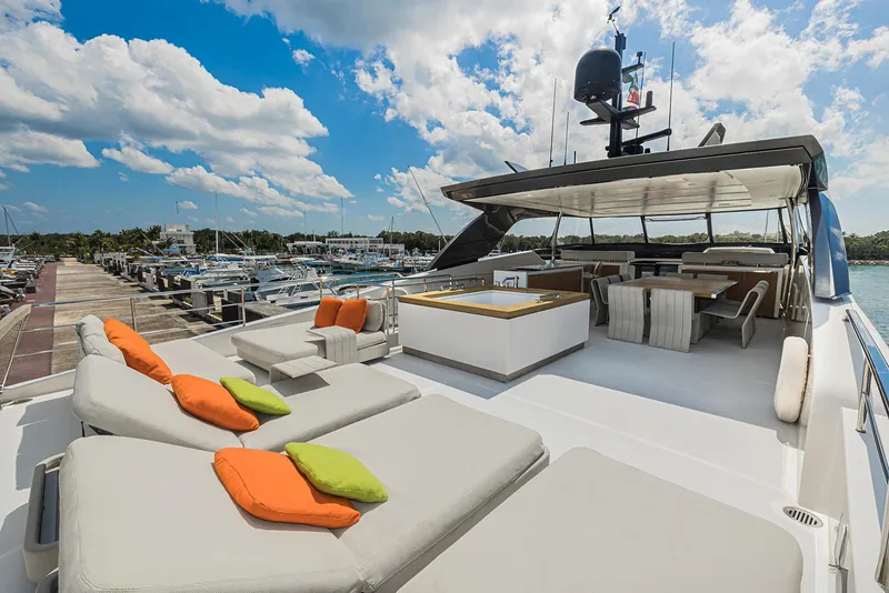 Slide: The Image of Luxurious 2014 Sanlorenzo SL104 yacht deck with sun loungers and vibrant cushions. - 14