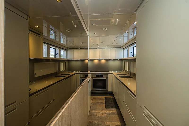Slide: The Image of Modern kitchen interior on 2014 Sanlorenzo SL104 yacht, featuring sleek cabinetry and appliances. - 23