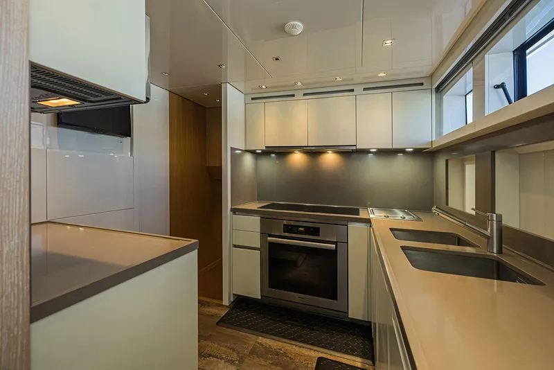 Slide: The Image of Modern kitchen interior on 2014 Sanlorenzo SL104 yacht, featuring sleek cabinetry and stainless steel appliances. - 25