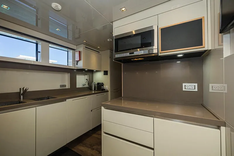 Slide: The Image of Modern kitchen interior on 2014 Sanlorenzo SL104 yacht, featuring sleek cabinetry and appliances. - 26