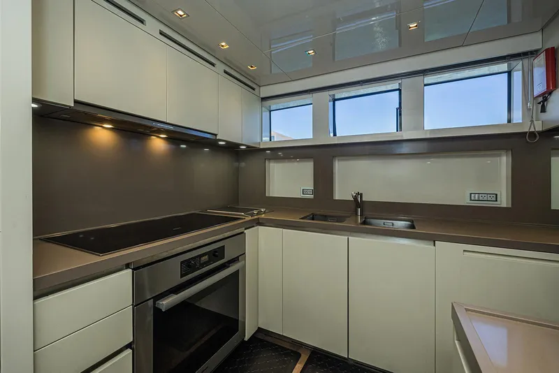 Slide: The Image of Modern kitchen interior on 2014 Sanlorenzo SL104 yacht, featuring sleek cabinetry and appliances. - 27